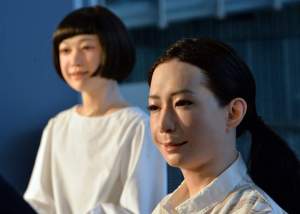 The new humanoid robots named "Otonaroid" (R) and "Kodomoroid (R) are pictured during a press preview at the National Museum of Emerging Science and Technology in Tokyo on June 24, 2014.  Japanese scientists unveiled what they said was the world's first news-reading android, eerily lifelike and possessing a sense of humour to match her perfect language skills.    AFP PHOTO / Yoshikazu TSUNO        (Photo credit should read YOSHIKAZU TSUNO/AFP/Getty Images)